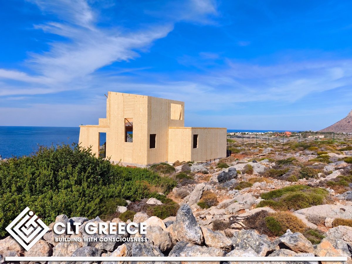 The two-storey CLT house in Chania, Crete, on the rocky coast of Chania overlooking the sea